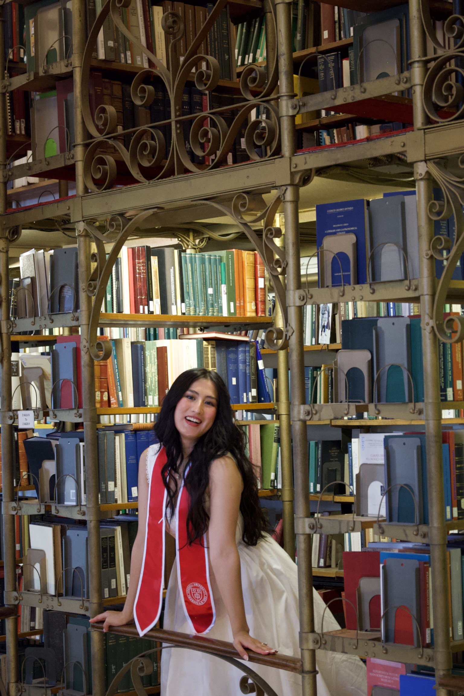 Andisha Safdariyan smiling in a Cornell library portrait